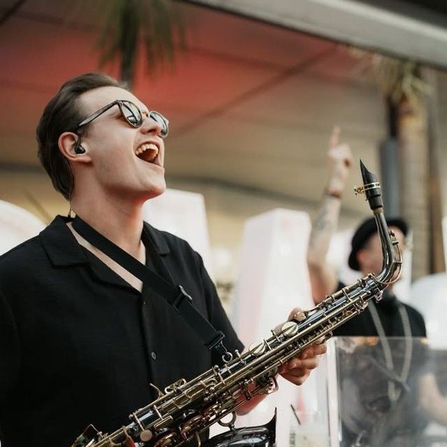 Saxophonist playing to the crowd at The Rock